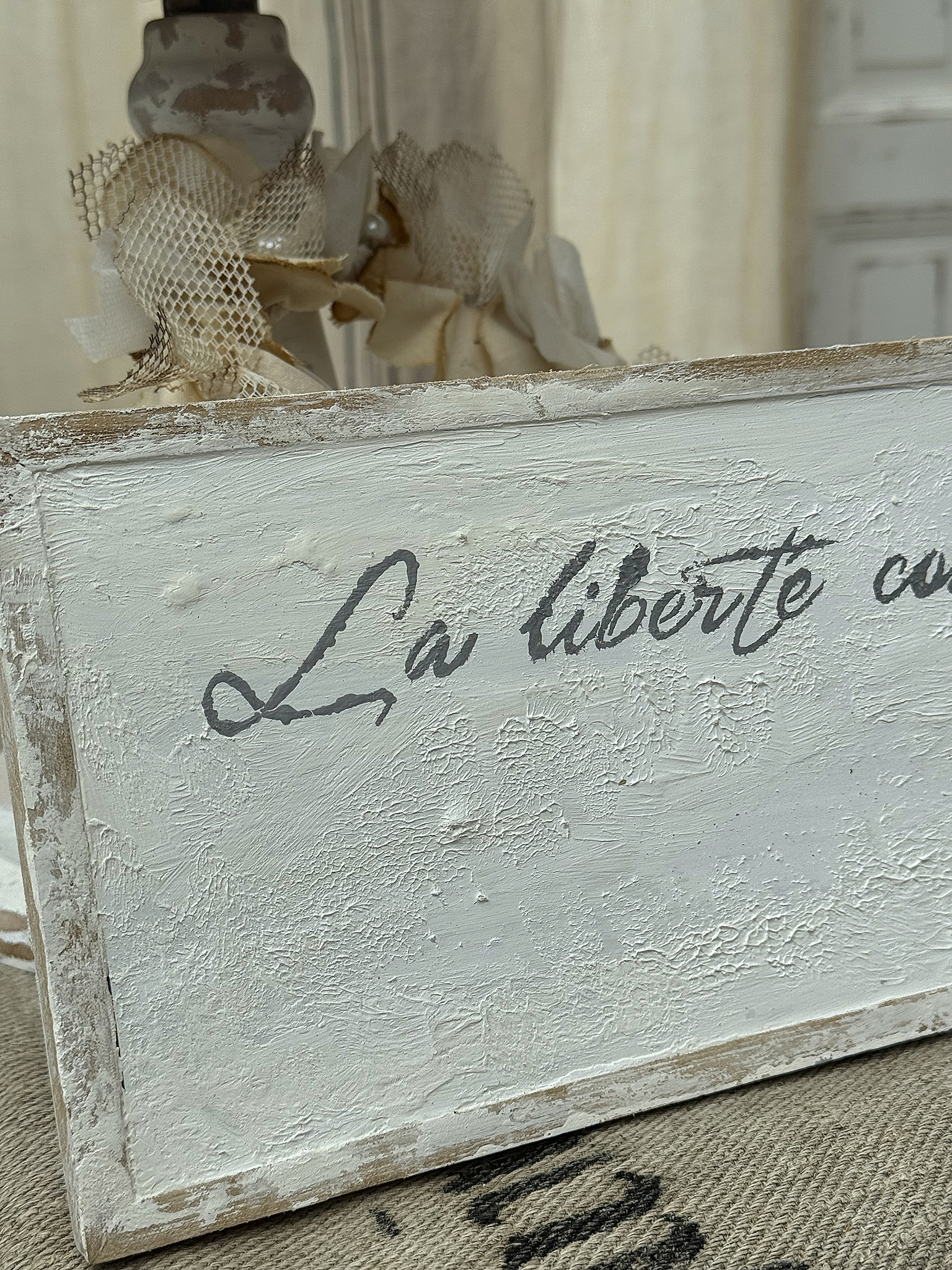 Dekoratives Schild mit dem Text 'La liberté' in elegantem Design.