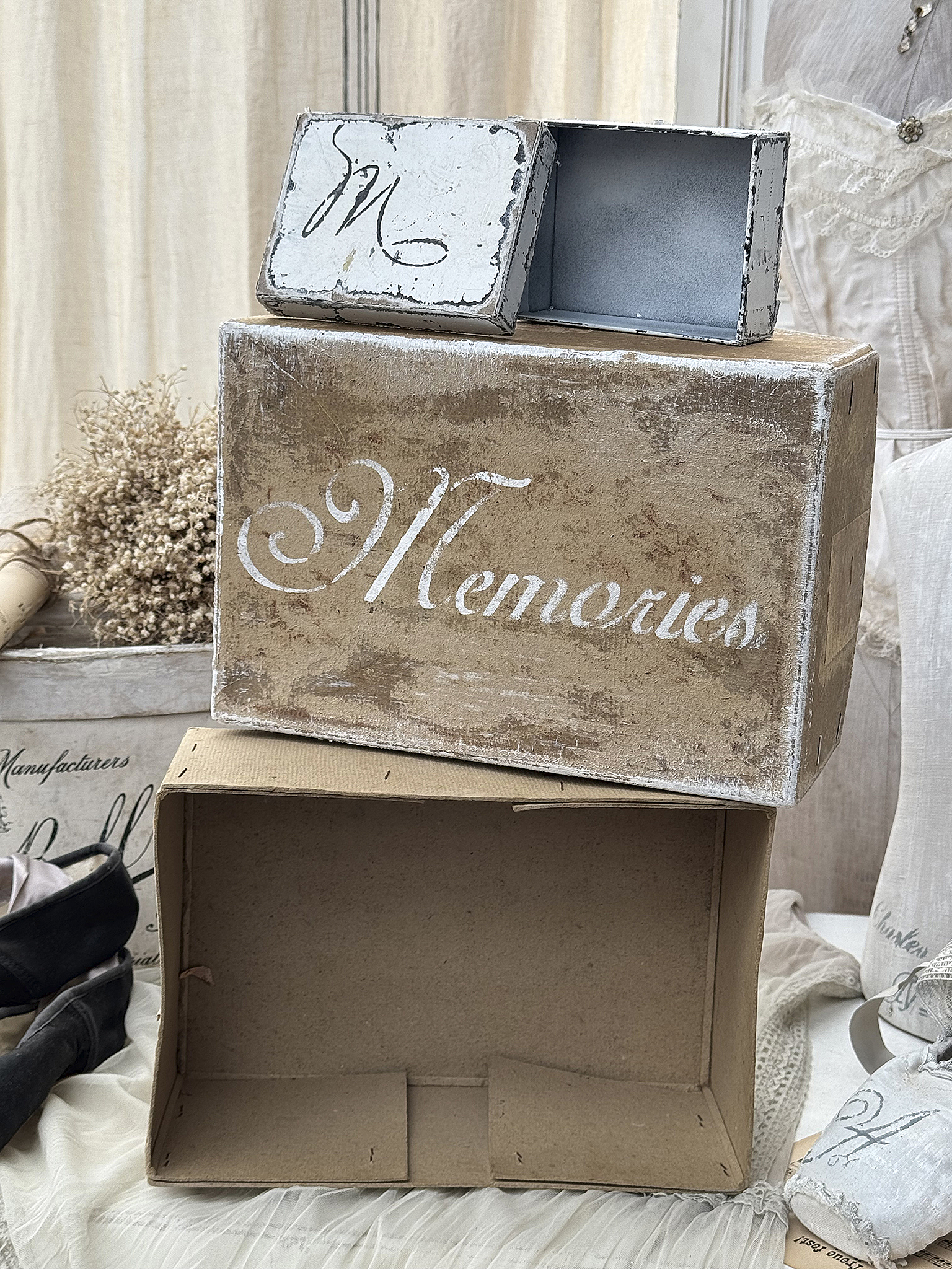 Zwei erinnerungswürdige, rustikale Boxen mit dem Schriftzug 'Memories' auf der größeren Box. Eine kleine Box steht oben drauf.